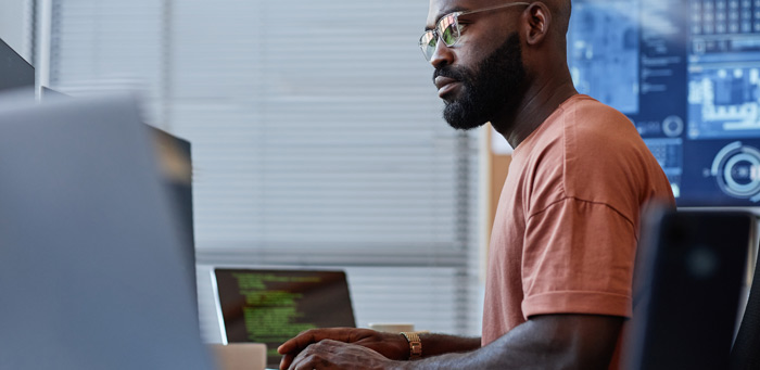 Man writing code on a computer