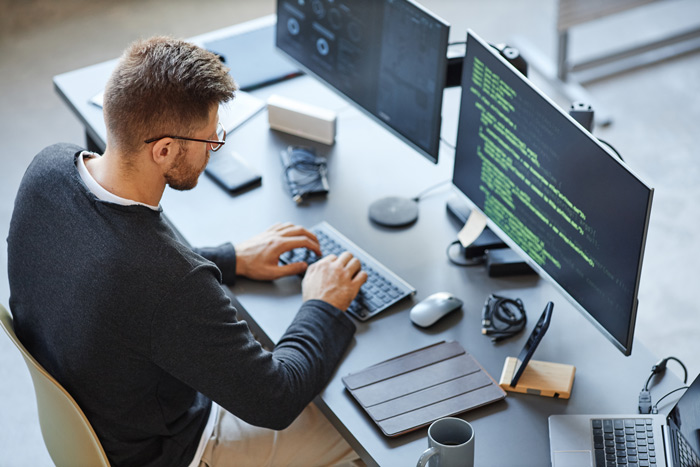 A man writing code on a computer